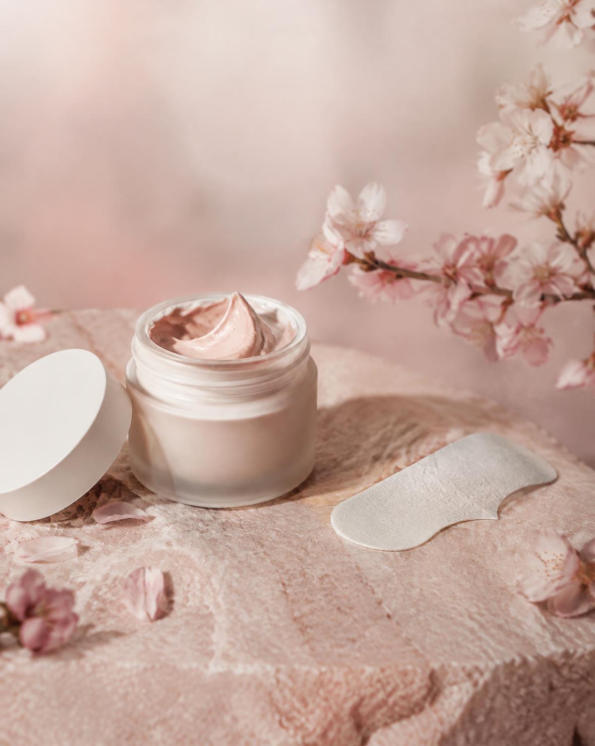 Clay mask jar and pore strip on pink stone